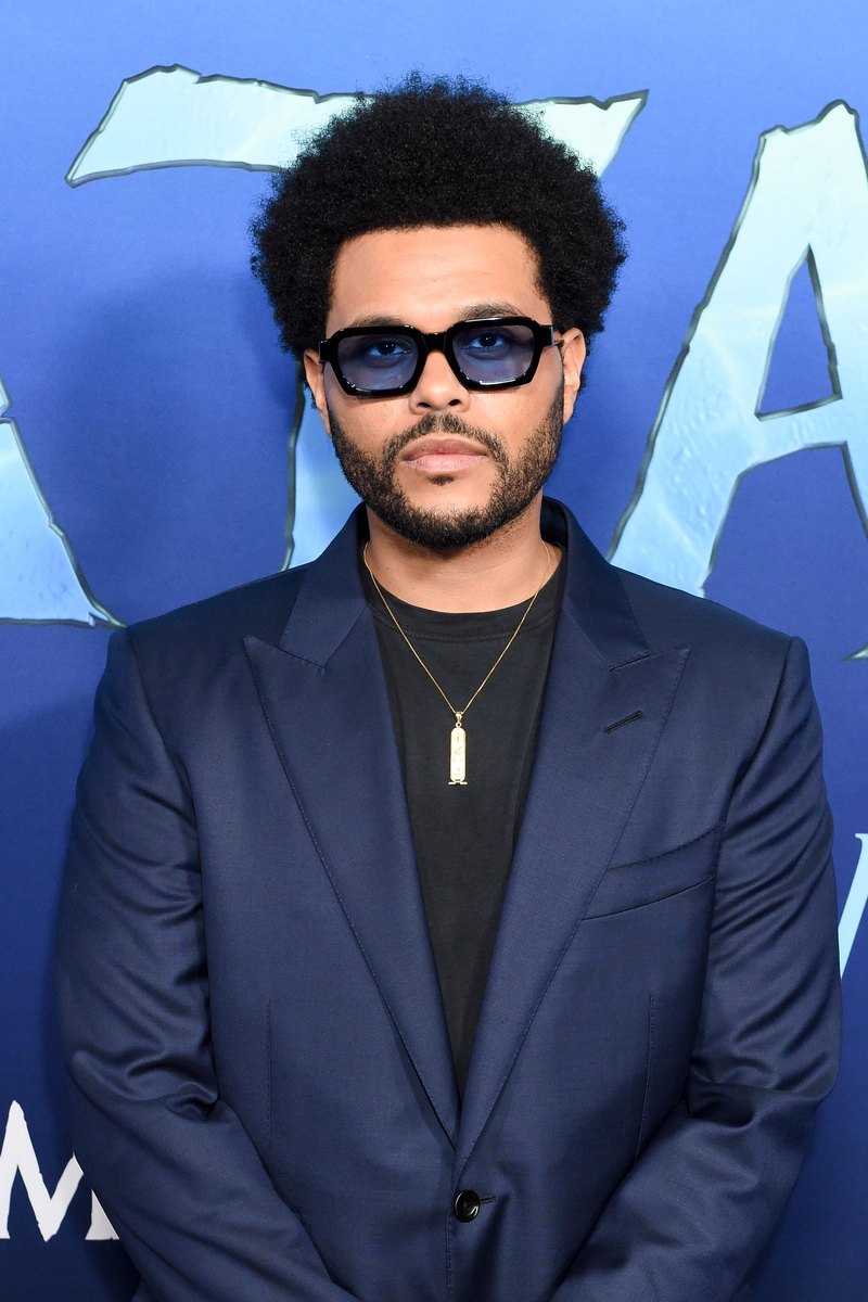 Man with a textured afro, low taper fade, and curly hair texture, styled with volume and definition