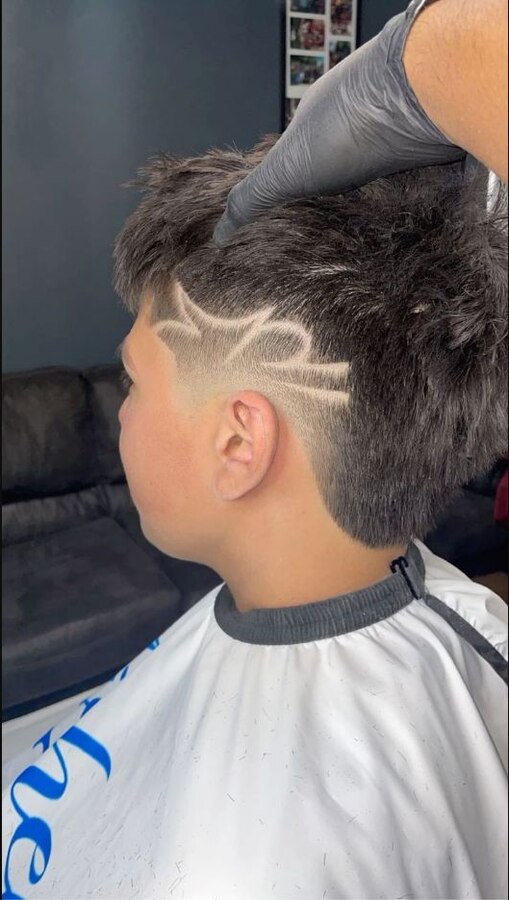 Burst fade with a simple shaved line following the curved semicircle behind the ear
