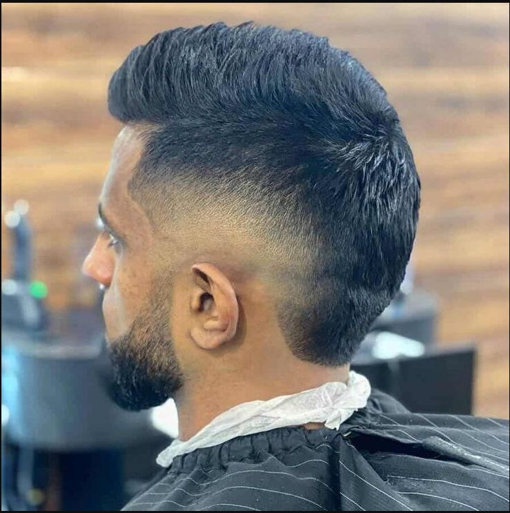 Modern matte pompadour with a rounded burst fade around and behind the ear