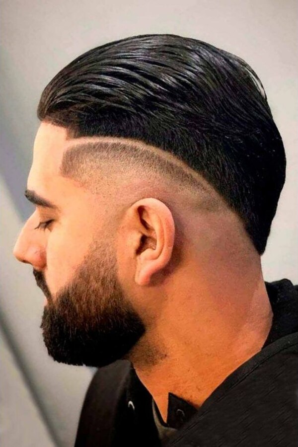Professional comb-over with a low burst taper and curved fade behind the ear