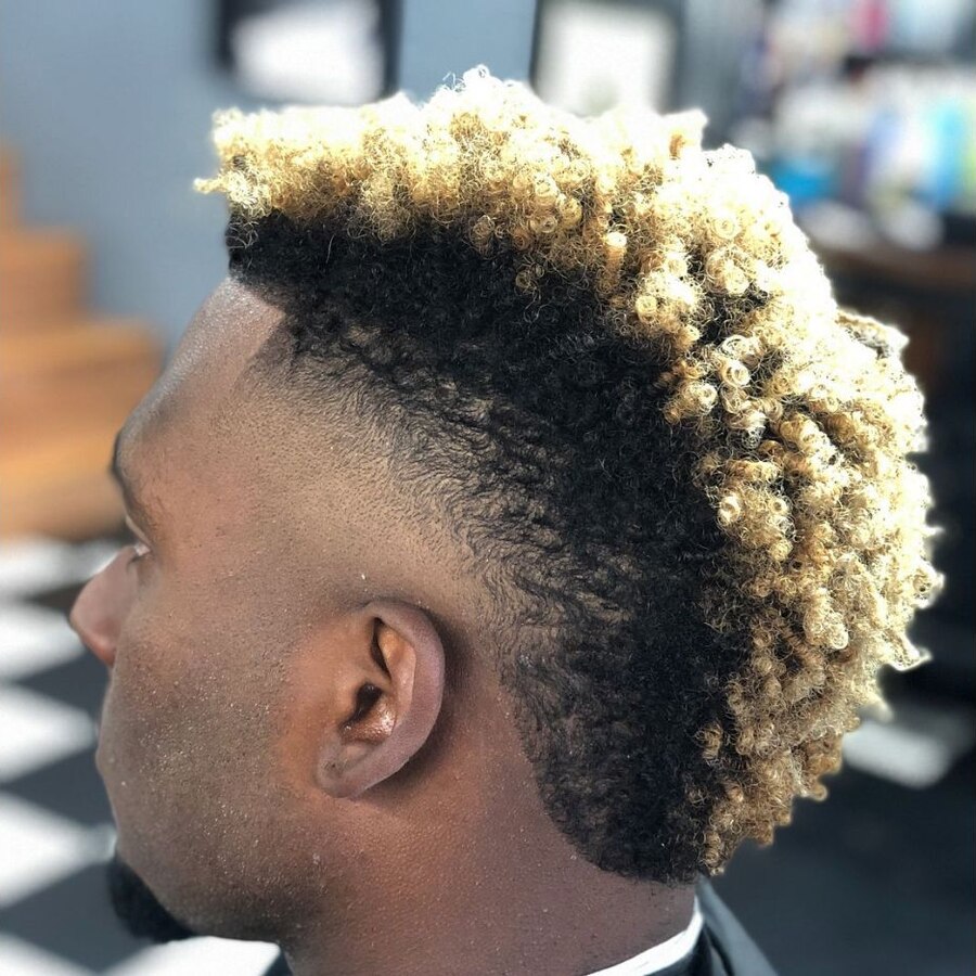 Sharp natural line-up with a rounded burst fade creating contrast around the ear